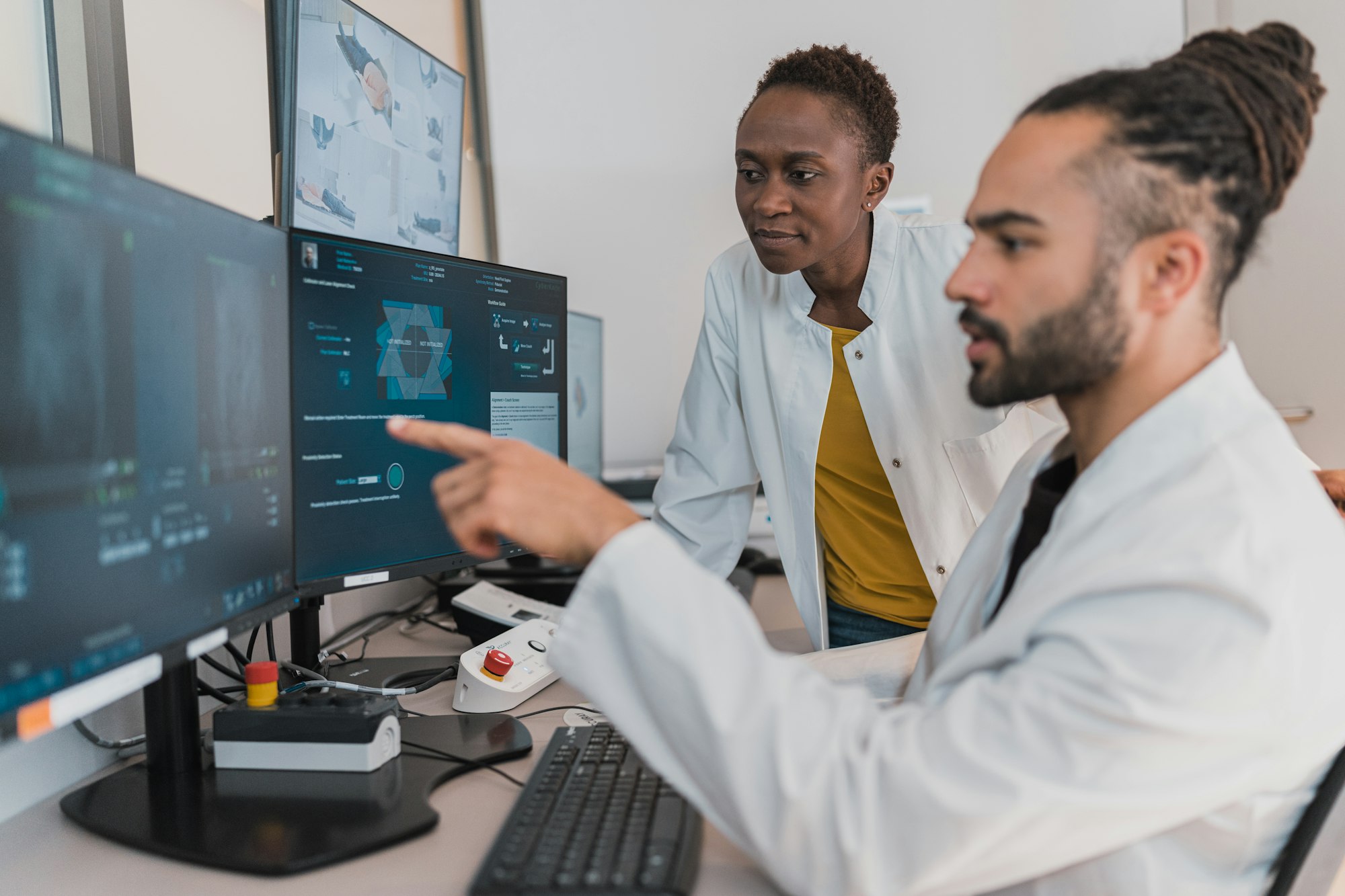 Clinicians reviewing a case on a laptop in a modern practice